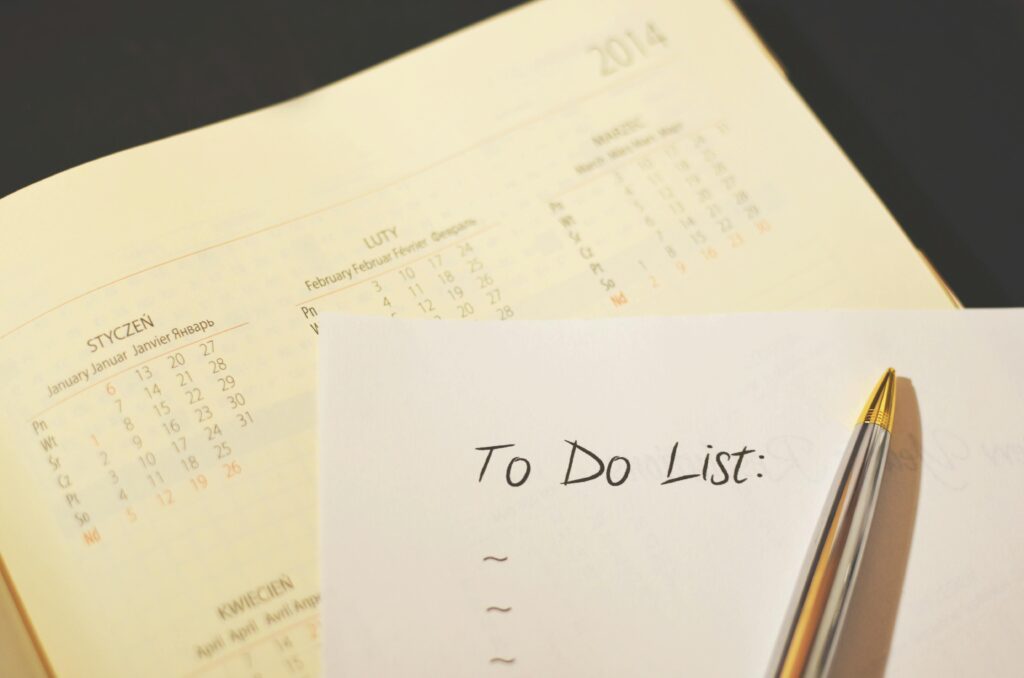 Close-up of a calendar and to-do list on a desk, emphasizing planning and organization.